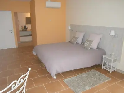 a bedroom with a large bed with two pillows at Les Jardins de Soulane B&B - Adults only in Belcastel-et-Buc