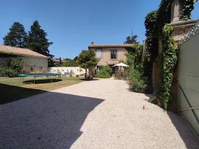a pathway in front of a building with a bench at The Cottage, Clos des Archers in Aigues-Vives