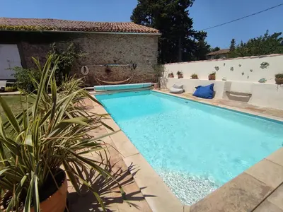 a swimming pool in the backyard of a house at The Cottage, Clos des Archers in Aigues-Vives