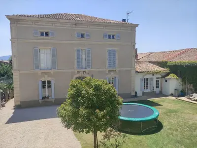 a large house with a swimming pool in front of it at The Cottage, Clos des Archers in Aigues-Vives