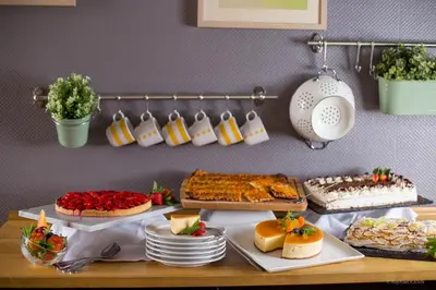 a table with many different types of cakes and desserts at Domaine de Garabaud in Mazères