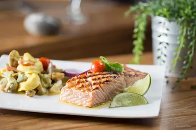a plate of food with fish and vegetables on a table at Domaine de Garabaud in Mazères