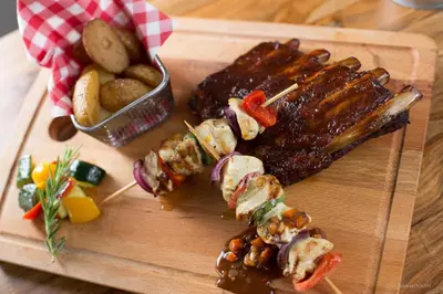 a cutting board with meat and other foods on it at Domaine de Garabaud in Mazères