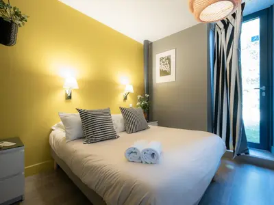 a bedroom with a bed with two towels on it at Domaine de Garabaud in Mazères