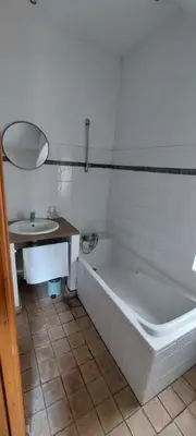 a white bathroom with a tub and a sink at La maison de maître in Cascastel-des-Corbières