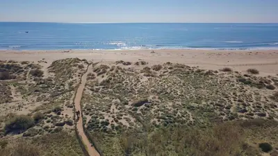 an aerial view of a sandy beach with the ocean at Gîtes la Vernède in Nissan-lez-Enserune