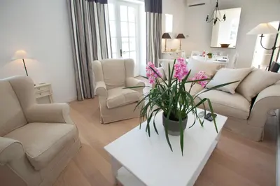 a living room with a vase of flowers on a table at Gîtes la Vernède in Nissan-lez-Enserune