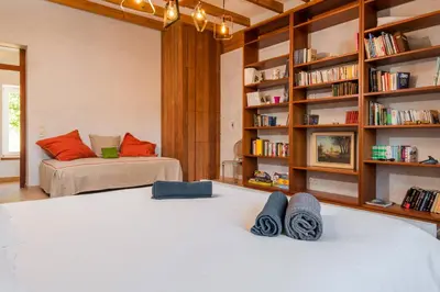 a bedroom with two beds and a book shelf at Domaine Calmel & Joseph in Montirat