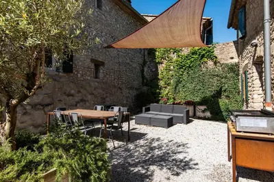 a patio with a wooden table and chairs at Domaine Calmel & Joseph in Montirat