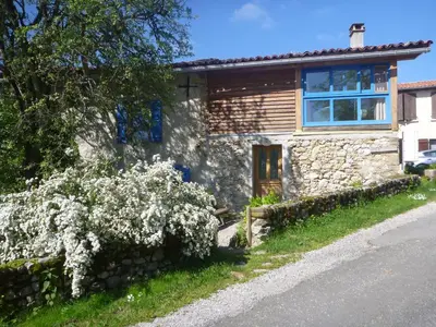 a stone house on the side of a road at Gite Sent Martin in Roquefixade