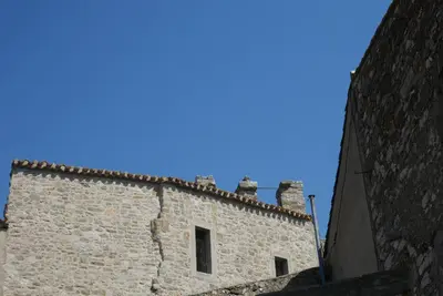 an old stone building with a blue sky in the background at C&O Appartements in Comigne