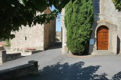 a building with a wooden door and a tree at C&O Appartements in Comigne