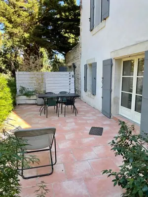 a patio with tables and chairs next to a building at C&O Appartements in Comigne
