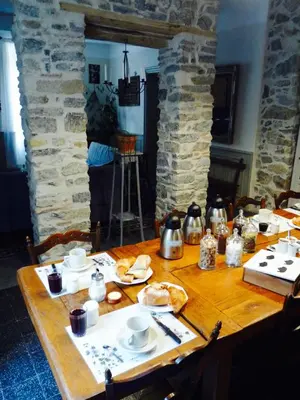 a wooden table with plates of food on it at Chez Lola-Maison d'hôtes Corbières in Durban-Corbières