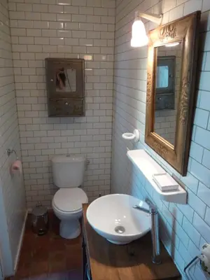 a bathroom with a toilet and a sink and a mirror at Chez Lola-Maison d'hôtes Corbières in Durban-Corbières