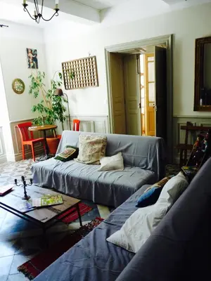 a living room with a couch and a table at Chez Lola-Maison d'hôtes Corbières in Durban-Corbières