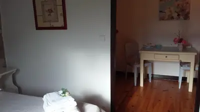 a bedroom with a bed and a desk with a table at L'Envolée in Belvianes-et-Cavirac