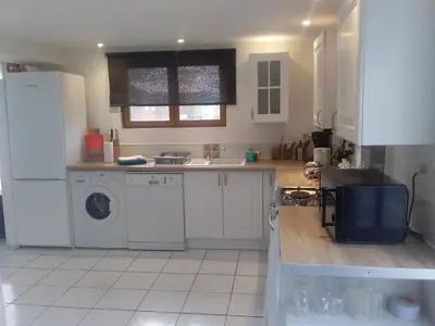 a kitchen with a sink and a washing machine at Gite Quatre Saisons 2 in Limoux