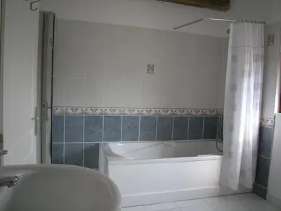 a bathroom with a tub and a sink and a bath tub at Gite Quatre Saisons 2 in Limoux