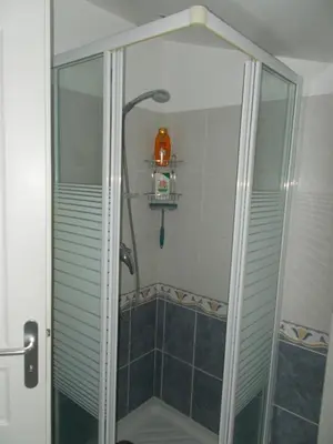 a shower with a glass door in a bathroom at Gite Quatre Saisons 2 in Limoux