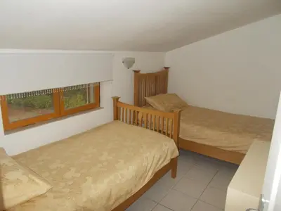 a small bedroom with two beds and a window at Gite Quatre Saisons 2 in Limoux