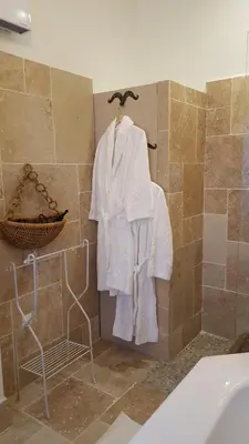 a bathroom with a sink and a mirror on a table at Château Moussoulens in Moussoulens