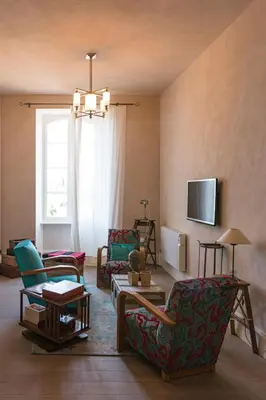 a living room with chairs and a couch and a window at Château Moussoulens in Moussoulens