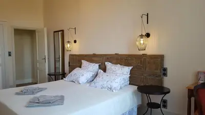 a living room with chairs and a couch and a tv at Château Moussoulens in Moussoulens
