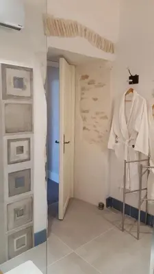 a bedroom with a large bed with a window at Château Moussoulens in Moussoulens