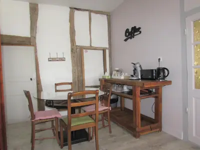 a dining room with a table and chairs at Les Balcons du Pastel in Puylaurens