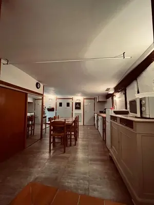 a kitchen and dining room with a table and chairs at Les Balcons du Pastel in Puylaurens