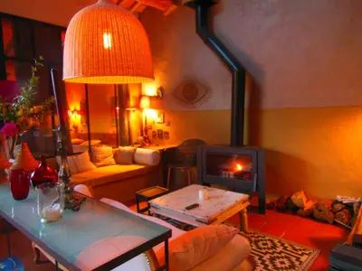 a living room with a wood stove in a living room at Loft Ecologique in Villesèque-des-Corbières