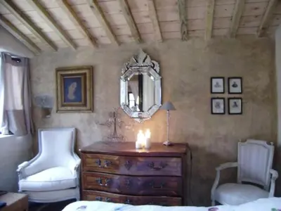 a bedroom with a candle on a dresser and a mirror at Loft Ecologique in Villesèque-des-Corbières