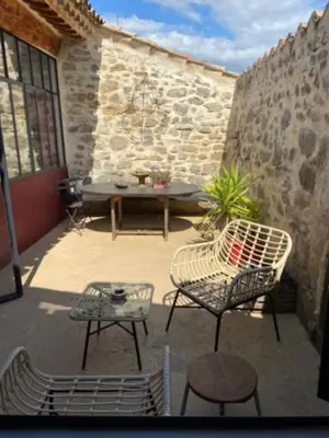 a patio with a table and two chairs and a table at Loft Ecologique in Villesèque-des-Corbières