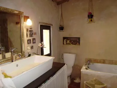 a bathroom with a tub and a sink and a toilet at Loft Ecologique in Villesèque-des-Corbières