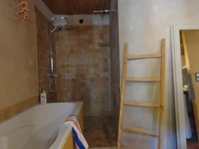 a bathroom with a bath tub and a ladder at Loft Ecologique in Villesèque-des-Corbières