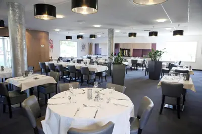 a dining room with white tables and chairs at The Originals City, Hôtel Le Causséa, Castres in Castres