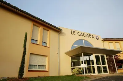 a building with a sign on the side of it at The Originals City, Hôtel Le Causséa, Castres in Castres