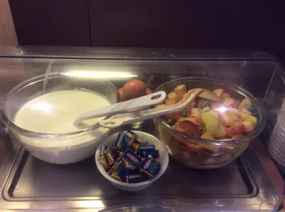 a tray of food with a salad and a bowl of food at The Originals City, Hôtel Le Causséa, Castres in Castres