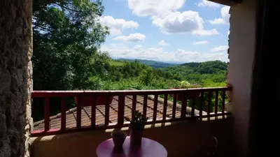 a view of a balcony with a table and a window at Terres de Barréjat in Cazals-des-Baylès