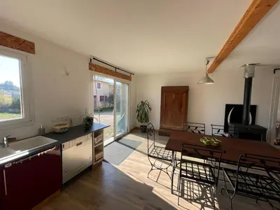 a kitchen and dining room with a table and chairs at Terres de Barréjat in Cazals-des-Baylès