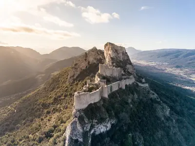 a castle on the side of a mountain at La Turquoise in Caves