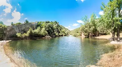 a river with trees on the side of it at La Turquoise in Caves