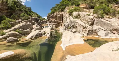 a pool of water with rocks in a mountain at La Turquoise in Caves