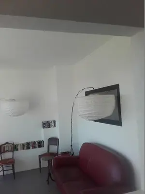 a dining room with a table and chairs and a large window at Chambre d'hôtes avec cuisine commune - 5 mns de Narbonne in Cuxac-dʼAude