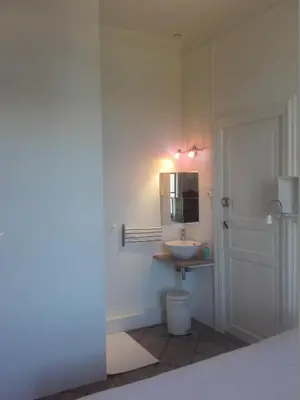 a living room with red chairs and a mirror at Chambre d'hôtes avec cuisine commune - 5 mns de Narbonne in Cuxac-dʼAude