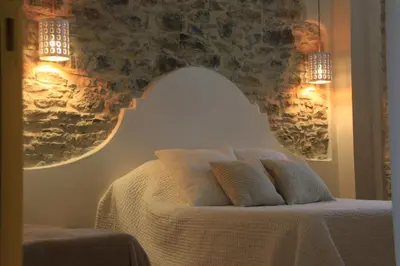a bedroom with a bed with two pillows on it at Le Logis GOUT in Carcassonne