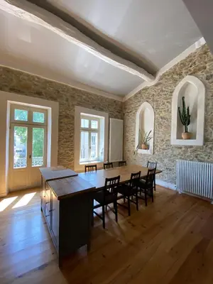 a large dining room with a table and chairs at Le Logis GOUT in Carcassonne