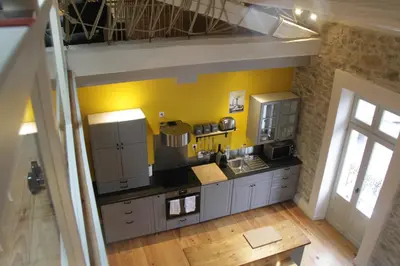 an overhead view of a kitchen with yellow walls at Le Logis GOUT in Carcassonne
