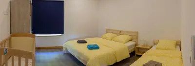 a small bedroom with two beds and a window at Domaine Le Piboul in Fontcouverte